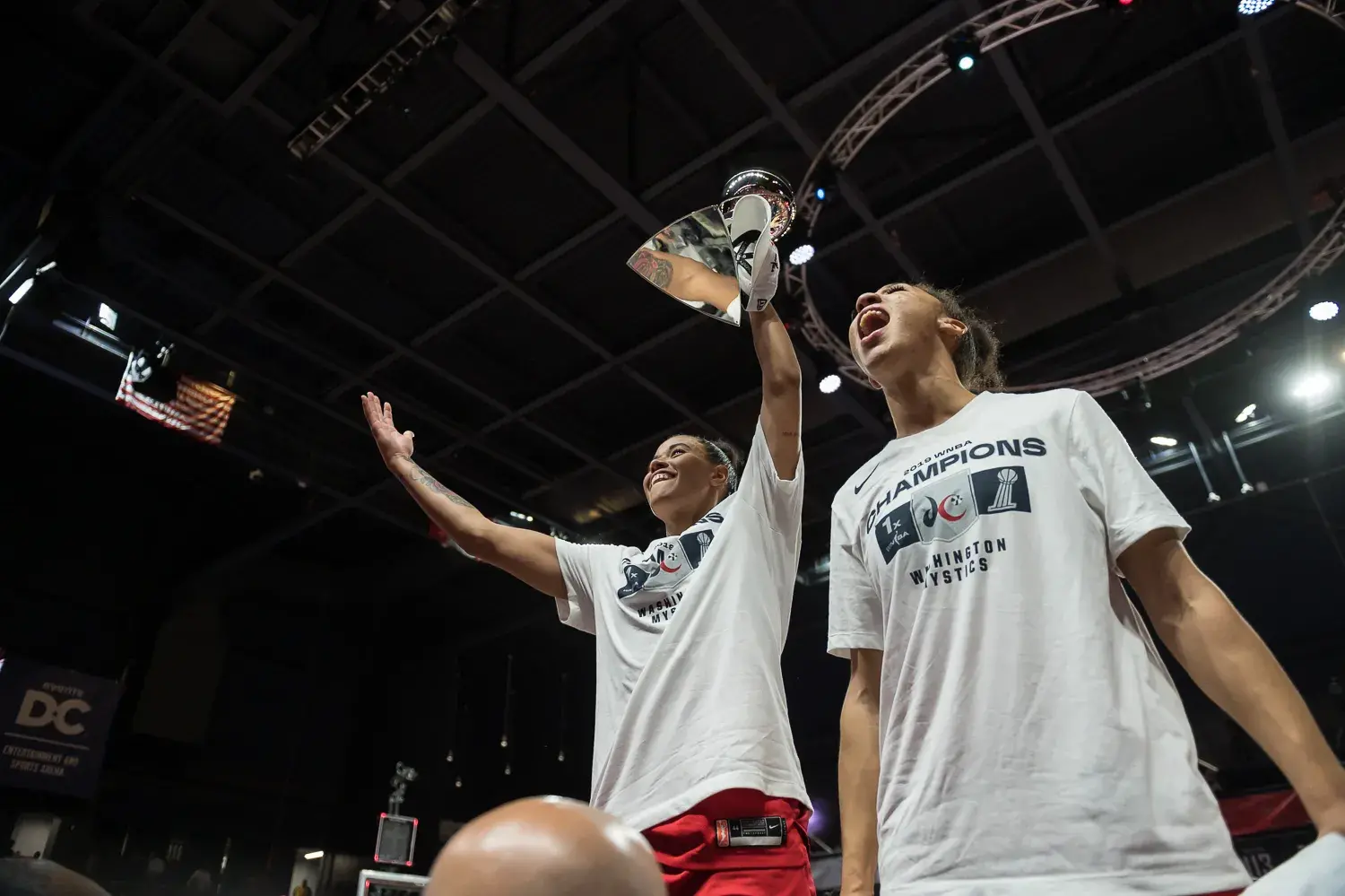 Mystics holding up 2019 WNBA Championship trophy at the Entertainment and Sports Arena.